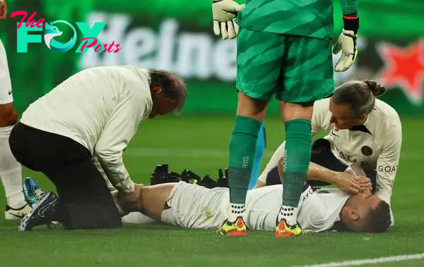 Soccer Football - Champions League - Semi Final - First Leg - Borussia Dortmund v Paris St Germain - Signal Iduna Park, Dortmund, Germany - May 1, 2024 Paris St Germain's Lucas Hernandez receives medical attention after sustaining an injury REUTERS/Thilo Schmuelgen