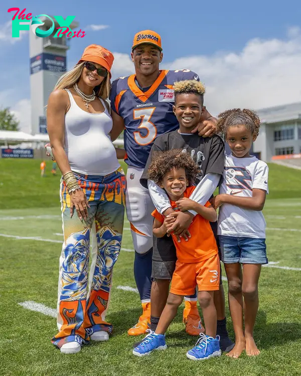 Ciara and Russell Wilson posing with their kids.