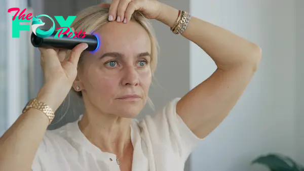 Celeb facialist Joanna Czech using the Lyma laser on her face