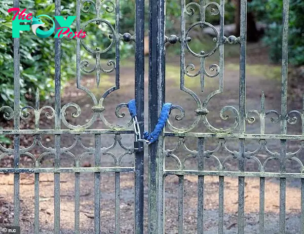 Gates are padlocked on the entrance to an eмpty мansion on the Wentworth estate