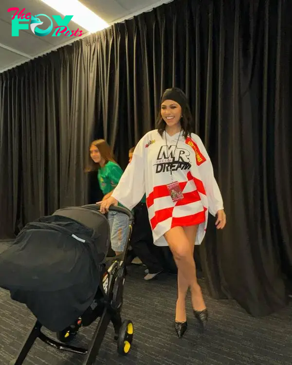Kourtney Kardashian holding a stroller