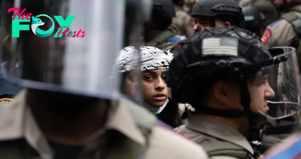 An arrested protester among state troopers during a walkout organized by the Palestine Solidarity Committee at the University of Texas at Austin on April 24.