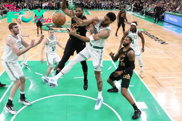 Jayson Tatum #0 of the Boston Celtics fights for the ball against Tristan Thompson #13 of the Cleveland Cavaliers 