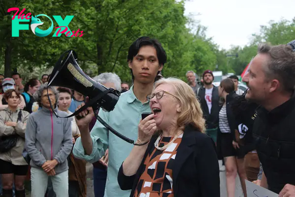 Indiana professor Barbara Dennis yells into a megaphone at the Rally for Resignations on April 29, at Bryan Hall. Dennis was arrested, along with 32 other protesters, at the pro-Palestinian encampment at Dunn Meadow the next day.