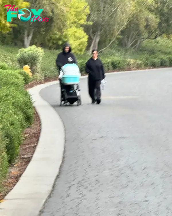 Travis Barker and Kourtney Kardashian walking with Rocky