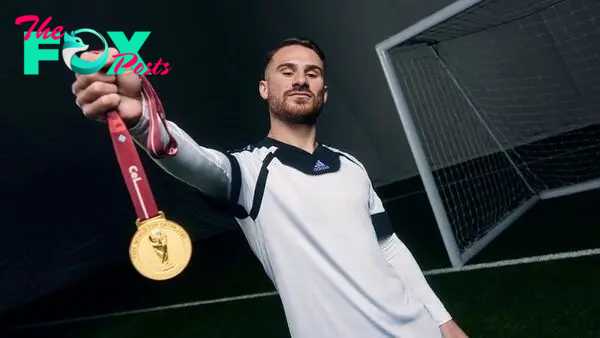 Brighton's Alexis Mac Allister with his World Cup medal for Argentina at an adidas shoot