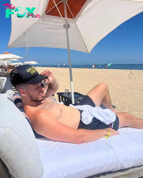 Vinny Guadagnino sitting on a beach