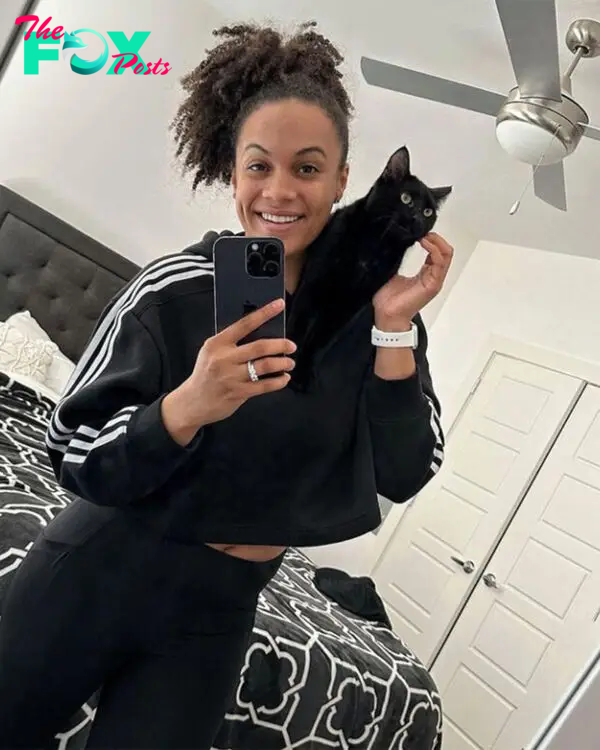 woman posing with cat on her shoulder