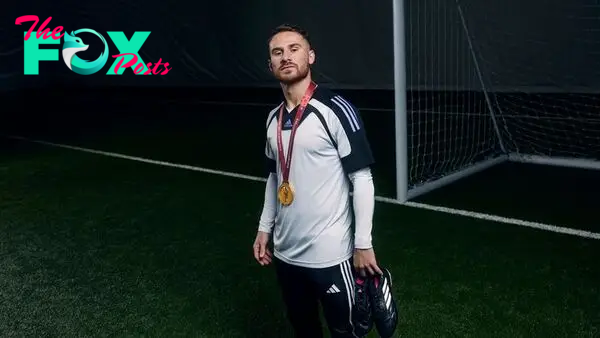 Brighton's Alexis Mac Allister with his World Cup medal for Argentina at an adidas shoot