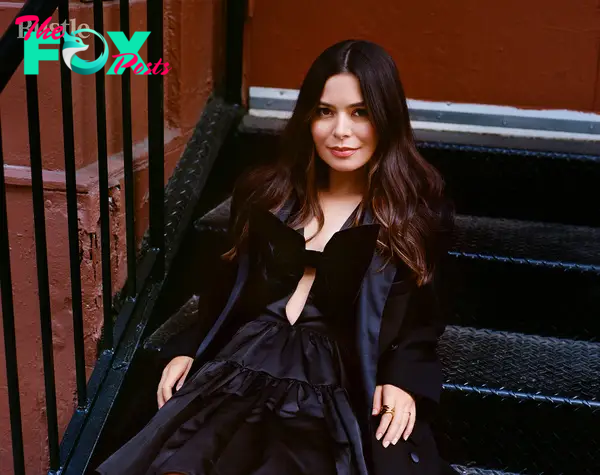 Miranda Cosgrove laying on steps.