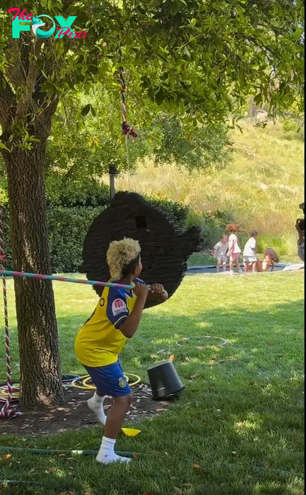 Saint West hitting a piñata