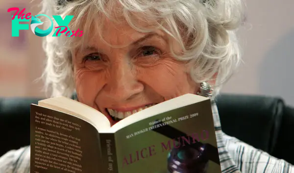 Munro holds one of her books as she receives her Man Booker International award at Trinity College Dublin, on June 25, 2009.