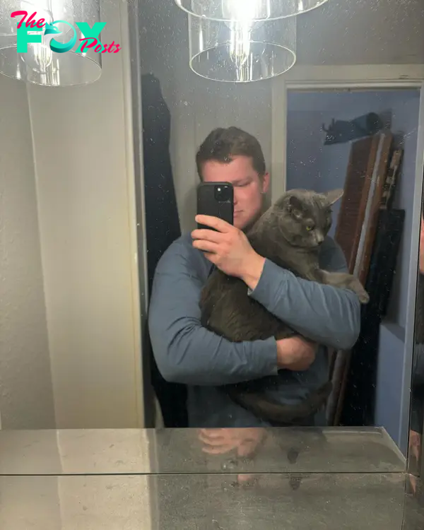 Garrison Brown holding a cat.