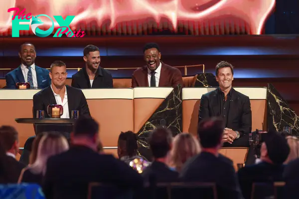 Rob Gronkowski (L) and Tom Brady (R) are seen onstage during sitting together 