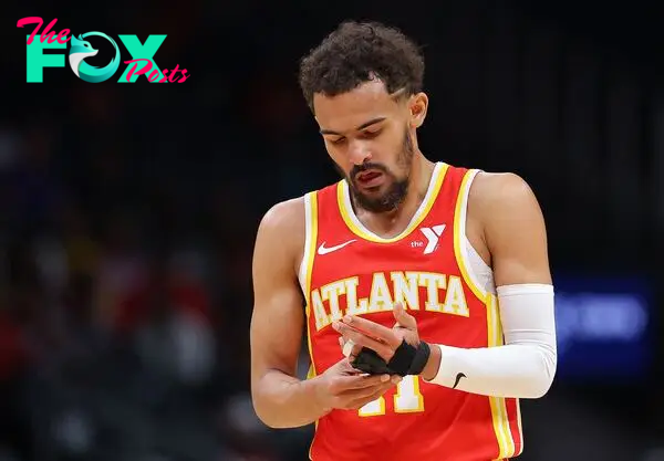 ATLANTA, GEORGIA - APRIL 10: Trae Young #11 of the Atlanta Hawks grabs his wrapped finger after drawing a foul against the Charlotte Hornets during the first quarter at State Farm Arena on April 10, 2024 in Atlanta, Georgia. NOTE TO USER: User expressly acknowledges and agrees that, by downloading and/or using this photograph, user is consenting to the terms and conditions of the Getty Images License Agreement.   Kevin C. Cox/Getty Images/AFP (Photo by Kevin C. Cox / GETTY IMAGES NORTH AMERICA / Getty Images via AFP)