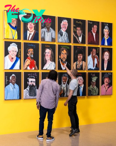 Vincent Namatjira looks at the installation of his exhibition, "Vincent Namatjira: Australia in colour," at the National Gallery of Australia.