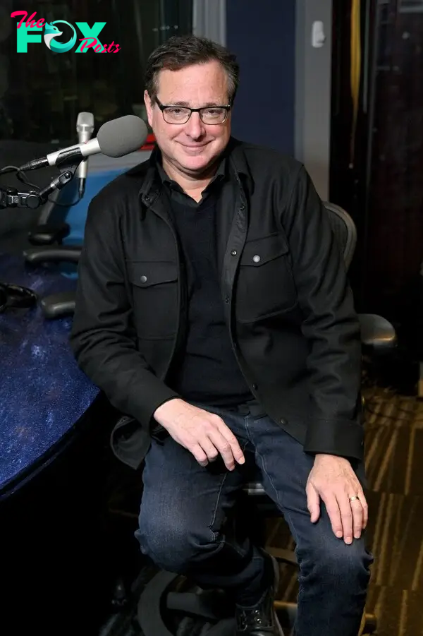 Bob Saget sitting down in 2019.