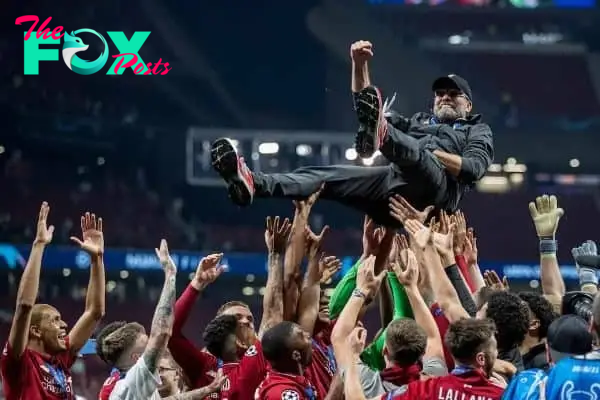 MADRID, SPAIN - SATURDAY, JUNE 1, 2019: Liverpool's players throw Liverpool Manager Jurgen Klopp in the air as they celebrate a 2-0 victory in the UEFA Champions League Final match between Tottenham Hotspur FC and Liverpool FC at the Estadio Metropolitano. (Pic by Paul Greenwood/Propaganda)