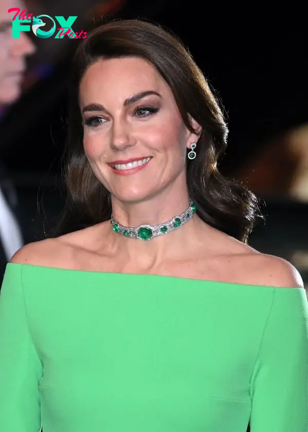 Princess Kate wearing a green emerald choker and green off the shoulder dress