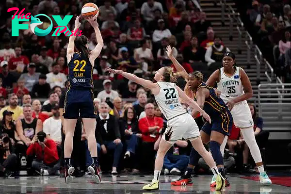 INDIANAPOLIS, INDIANA - MAY 16: Caitlin Clark #22 of the Indiana Fever attempts a shot while being guarded by Courtney Vandersloot #22 of the New York Liberty in the first quarter at Gainbridge Fieldhouse on May 16, 2024 in Indianapolis, Indiana.