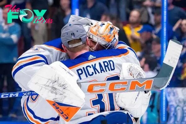 Edmonton Oilers goalie Calvin Pickard (30) and goalie Stuart Skinner (74) celebrate their victory over the Vancouver Canucks in game seven of the second round of the 2024 Stanley Cup Playoffs at Rogers Arena.