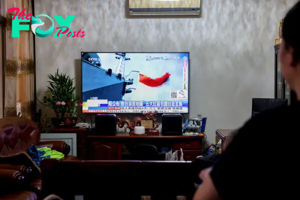 A resident on Lieyu Township watches the news of China's drills around Taiwan in Kinmen on May 23, 2024.