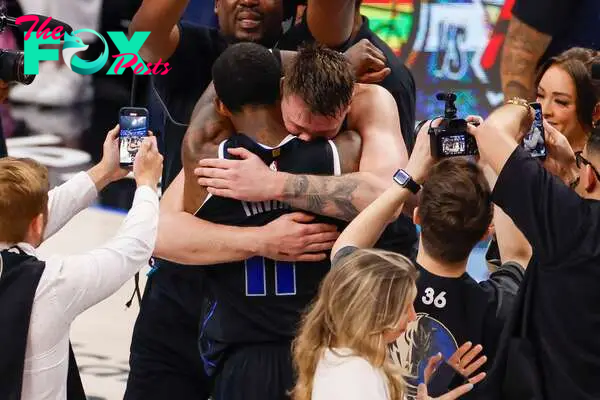 Luka Doncic hugs Kyrie Irving after defeating the Oklahoma City Thunder in the Western Conference Semifinal.