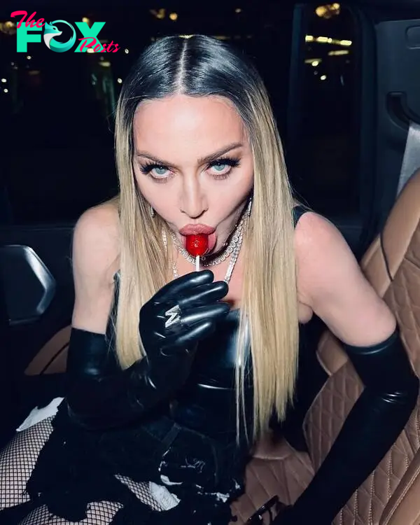 Madonna eating a lollipop.