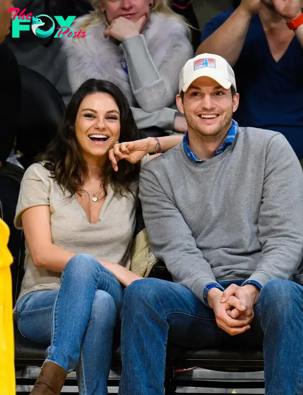 Mila Kunis and Ashton Kutcher watching basketball