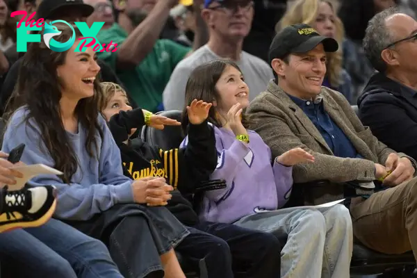 Mila Kunis and Ashton Kutcher with their kids, Wyatt and Dimitri, watching basketball