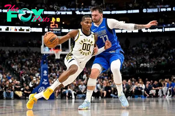 Mar 5, 2024; Dallas, Texas, USA; Indiana Pacers guard Bennedict Mathurin (00) brings the ball up court past Dallas Mavericks guard Luka Doncic (77) during the second half at the American Airlines Center. Mandatory Credit: Jerome Miron-USA TODAY Sports