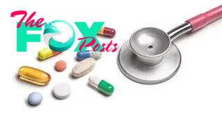 A variety of pills beside a stethoscope.