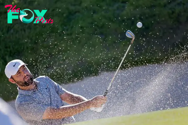 Scottie Scheffler hits from a green side bunker on the 18th hole during the third round of the 2024 PGA Championship.