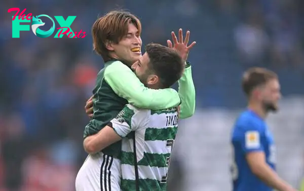 Celtic player Kyogo Furuhashi celebrates with Greg Taylor after the Scottish Cup Final between Rangers and Celtic  at Hampden Park on May 25, 2024 ...