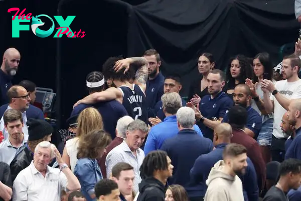 Dallas Mavericks center Dereck Lively II (2) leaves the court after a neck injury in the second quarter.