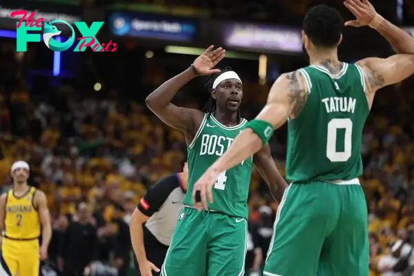 Boston Celtics guard Jrue Holiday (4) celebrates with forward Jayson Tatum (0) after drawing a foul against the Indiana Pacers in the closing seconds of the fourth quarter of game three of the eastern conference finals in the 2024 NBA playoffs at Gainbridge Fieldhouse.