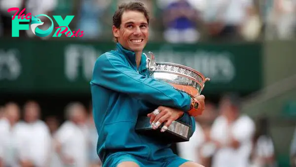 Nadal celebrates with the trophy after winning the 2018 final against Dominic Thiem.