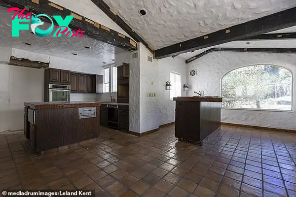 The property has large windows to allow in a lot of light. The kitchen area is pictured here