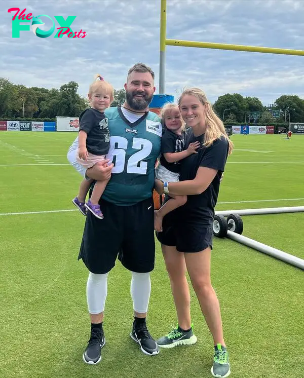 Jason and kylie Kelce holding their daughters