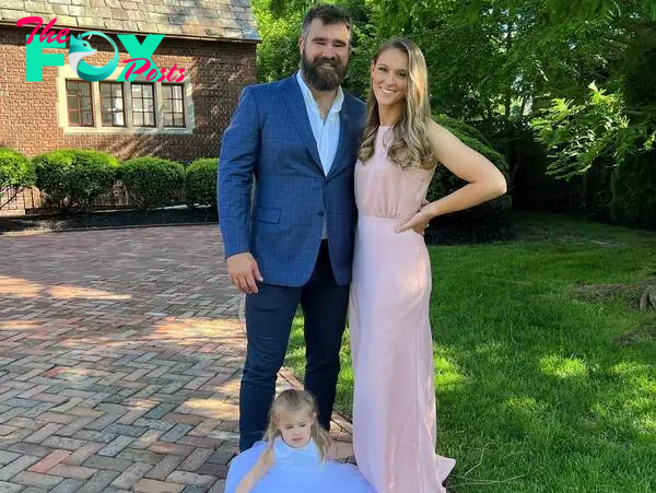 Jason Kelce and Kylie Kelce posing with their daughter