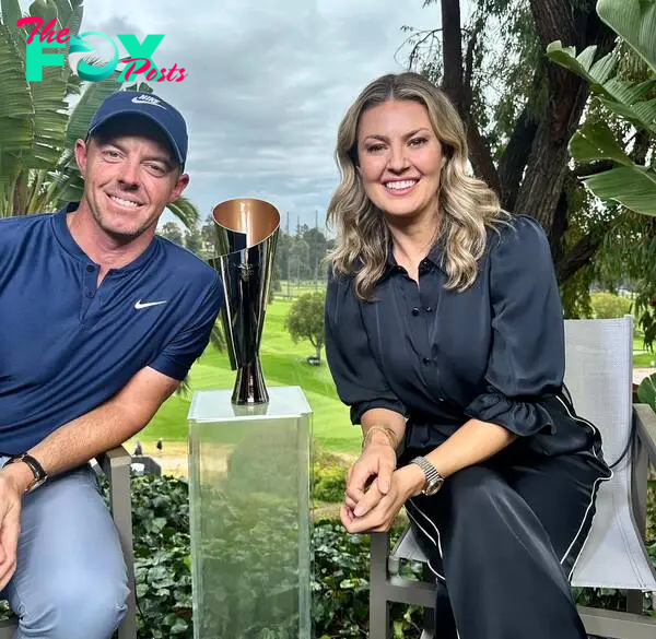 rory mcilroy and amanda balionis sitting next to a trophy