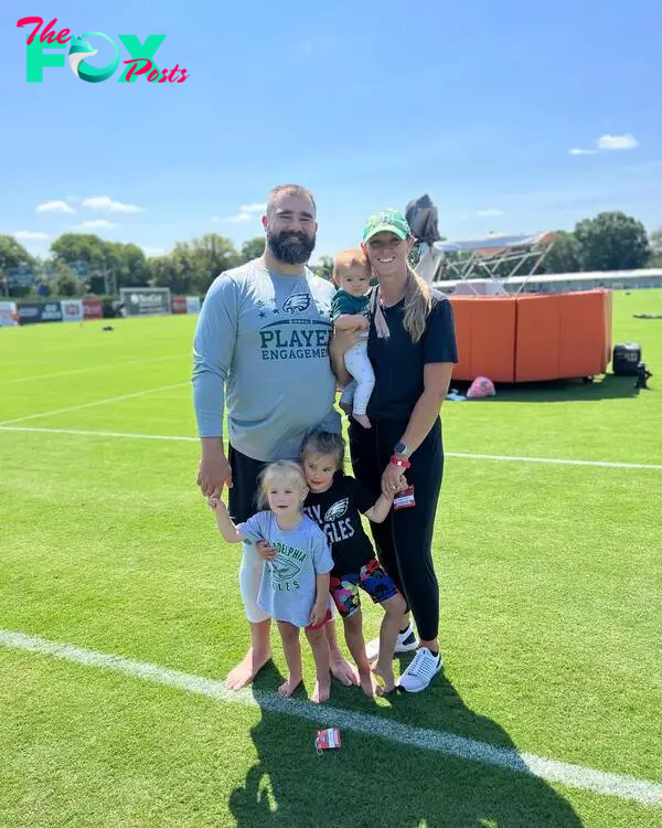 Jason Kelce and Kylie Kelce posing with their daughters