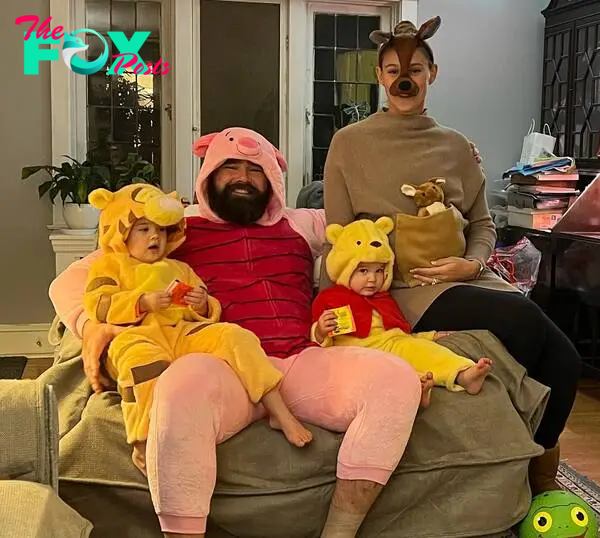 Jason Kelce and Kylie Kelce posing with their three daughters