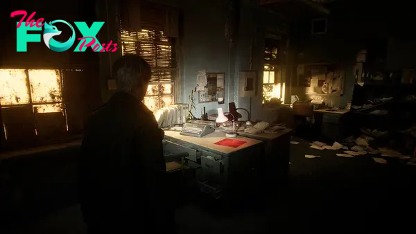 This images shows James standing in an office-like environment. Papers are strewn over the floor, with the setting illuminated by a glimmer of light from three sets of grimy windows.