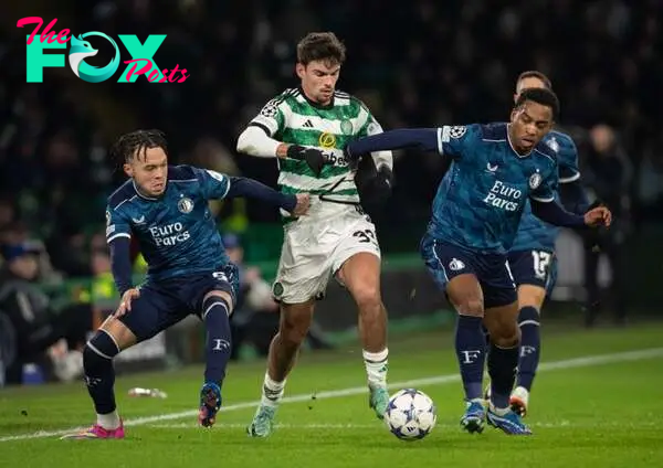 Matt O'Riley of Celtic in action with Quilindschy Hartman and Quinten Timber of Feyenoord during the UEFA Champions League match between Celtic FC ...