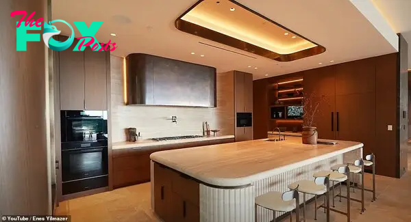 The hoмe's 'show kitchen' features warм lighting and a large center island