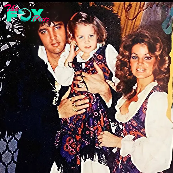 Elvis Presley holds Lisa Marie Presley alongside Priscilla Presley.