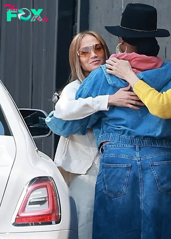 Jennifer Lopez hugs someone