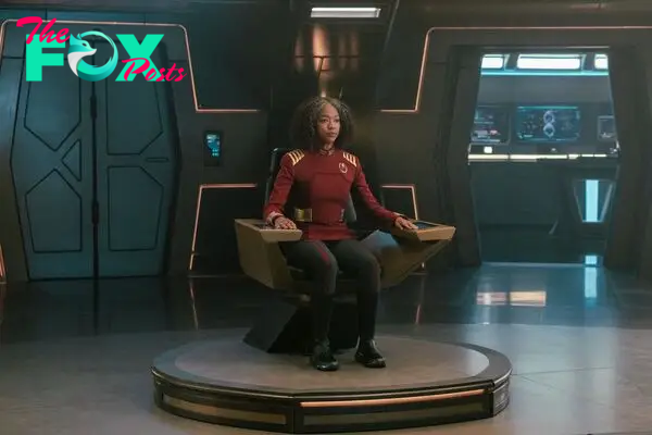 Sonequa Martin-Green as Burnham in Star Trek Discovery, sitting in the captain chair in the series finale 