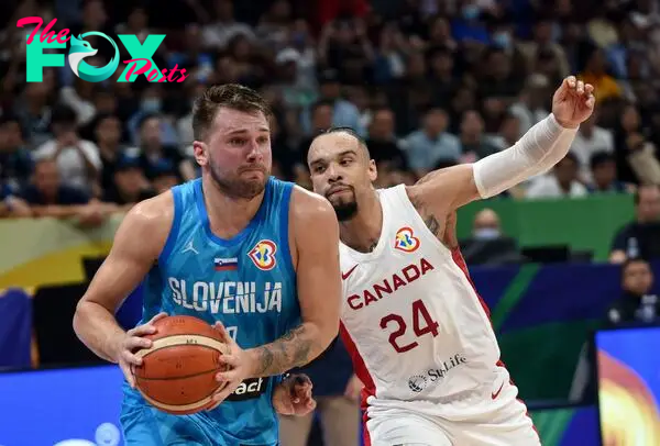 Basketball - FIBA World Cup 2023 - Quarter-Final - Canada v Slovenia - Mall of Asia Arena, Manila, Philippines - September 6, 2023 Slovenia's Luka Doncic in action with Canada's Dillon Brooks REUTERS/Lisa Marie David